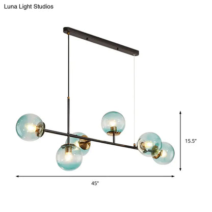 Modern black metal 6-light island pendant with five translucent teal glass globes and adjustable cord by decorbites