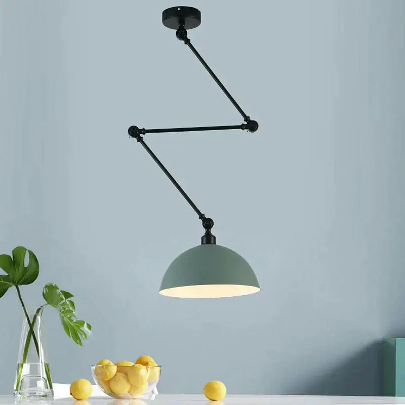 Black articulated arm ceiling pendant light with matte sage green dome shade and adjustable long arm for living room