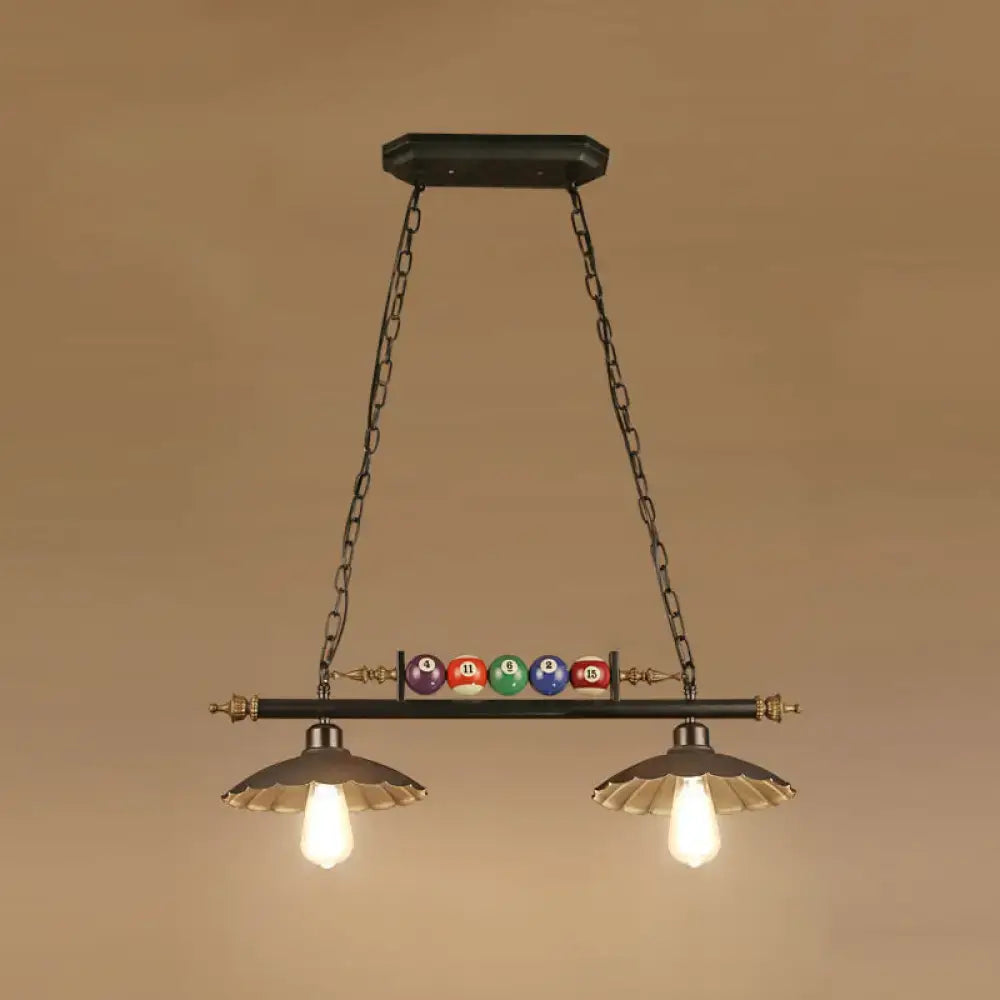 Black metal industrial style hanging light fixture with brass accents and billiard ball deco with exposed bulbs