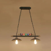 Black metal industrial style hanging light fixture with brass accents and billiard ball deco with exposed bulbs