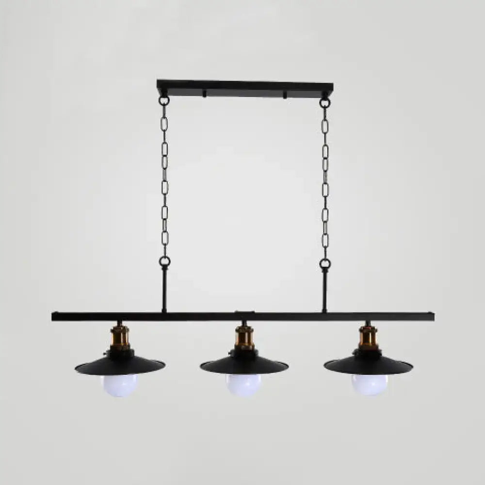 Black industrial-style metal kitchen ceiling light with three exposed bulbs and brass accents for flat shade island lighting