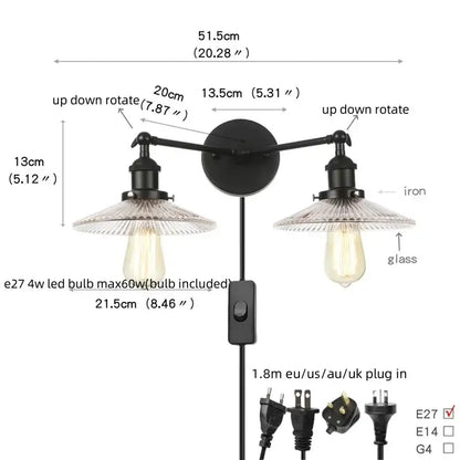 Black iron industrial wall light fixture with two adjustable arms and exposed edison bulbs for bedroom sconce use