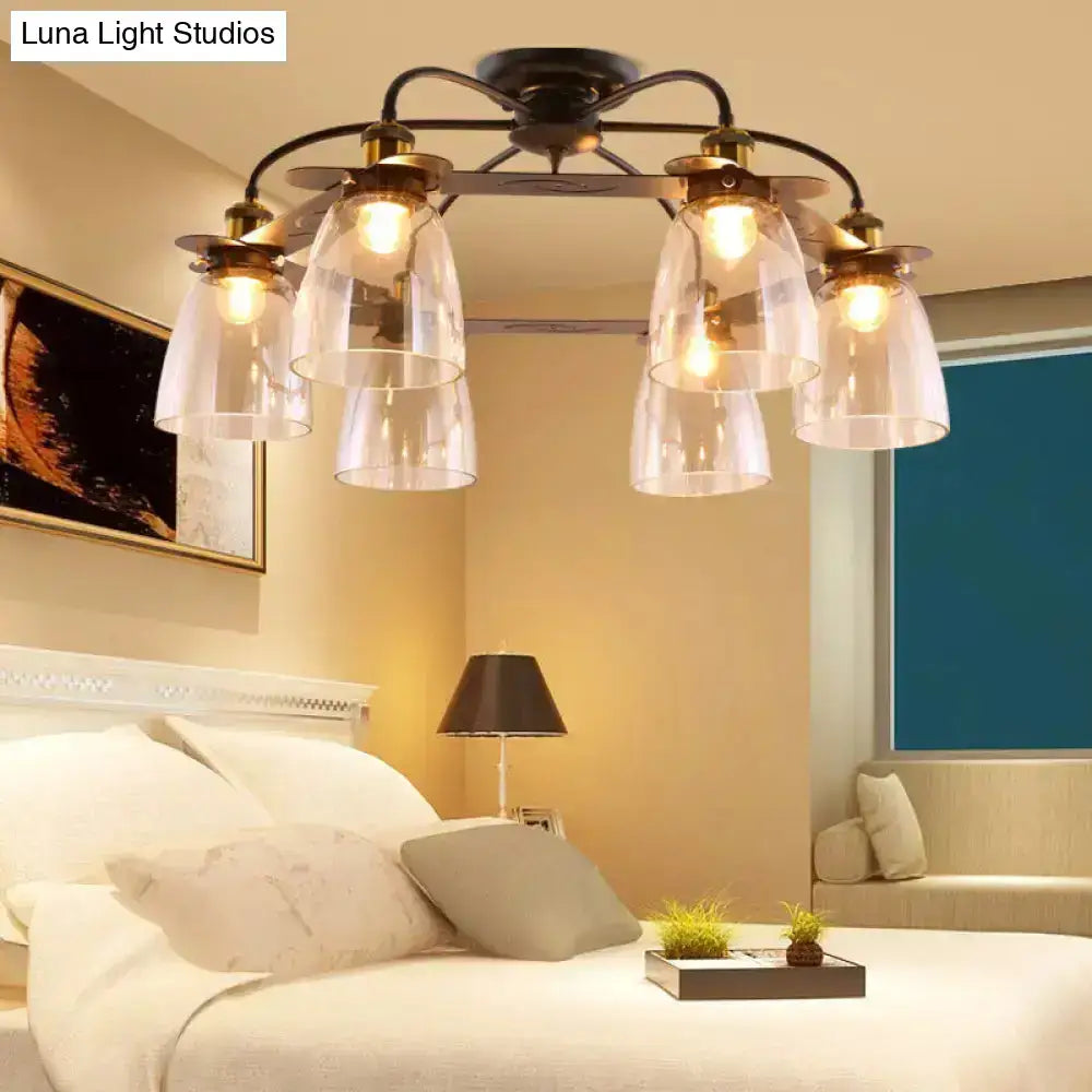Black wrought iron ceiling lamp with five cognac glass bell shades and brass accents for living room decor