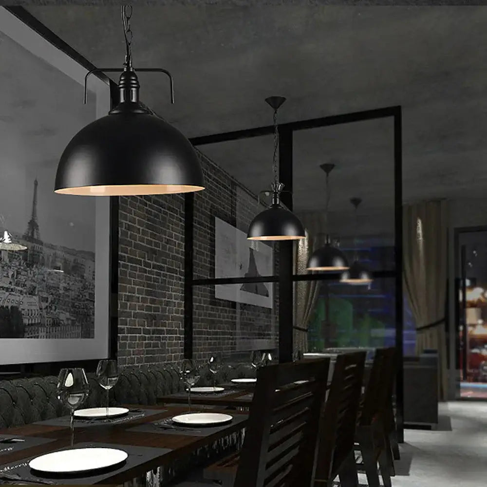 Industrial black iron pendant light with matte finish and warm-toned interior for kitchen decorbites iron pendant lighting