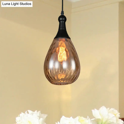 A daisy industrial black ceiling light with a teardrop-shaped amber glass pendant and black metal fixture