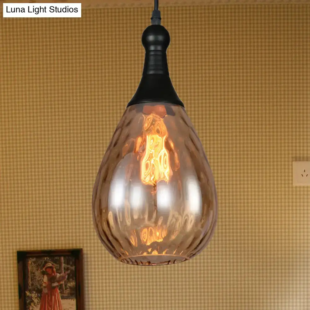 A warm-toned industrial black brass ceiling light with textured amber glass pendant from DecorBites daisy industrial black series