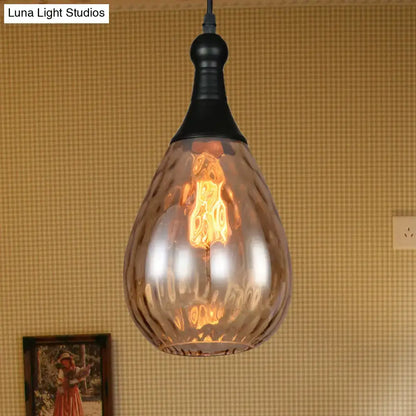 A warm-toned industrial black brass ceiling light with textured amber glass pendant from DecorBites daisy industrial black series