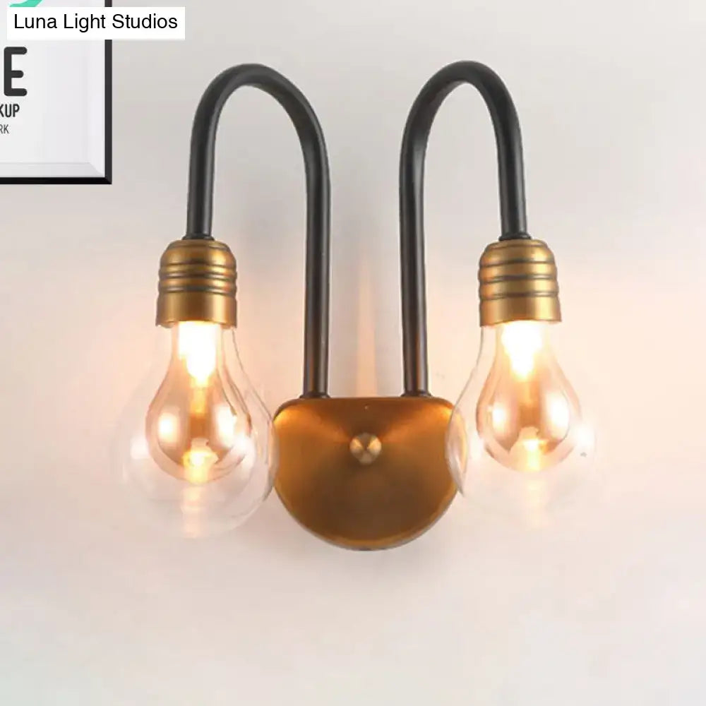 Industrial black and brass wall lamp with two curved metal arms and edison bulbs perfect for bedroom lighting fixture width compact