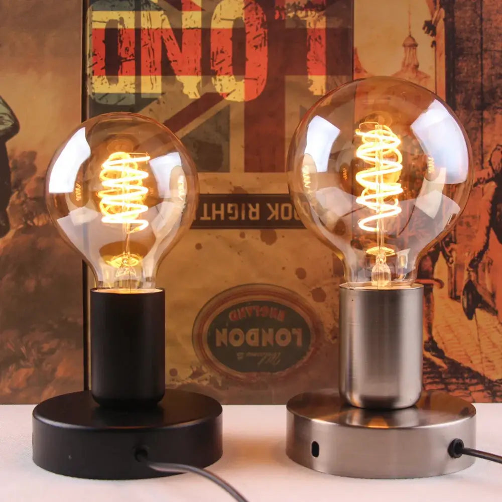 Two vintage-style edison bulb desk lamps with industrial black and bronze lamp bases for bedroom use