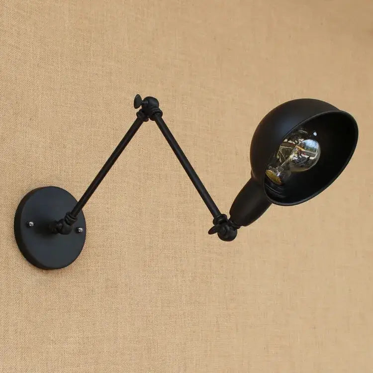 Black matte industrial wall lamp with articulated arms and visible filament bulb from decorbites black edison retro style