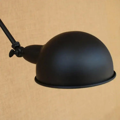 Industrial black edison retro wall lamp with black matte dome-shaped shade and slender articulated arm by decorbites