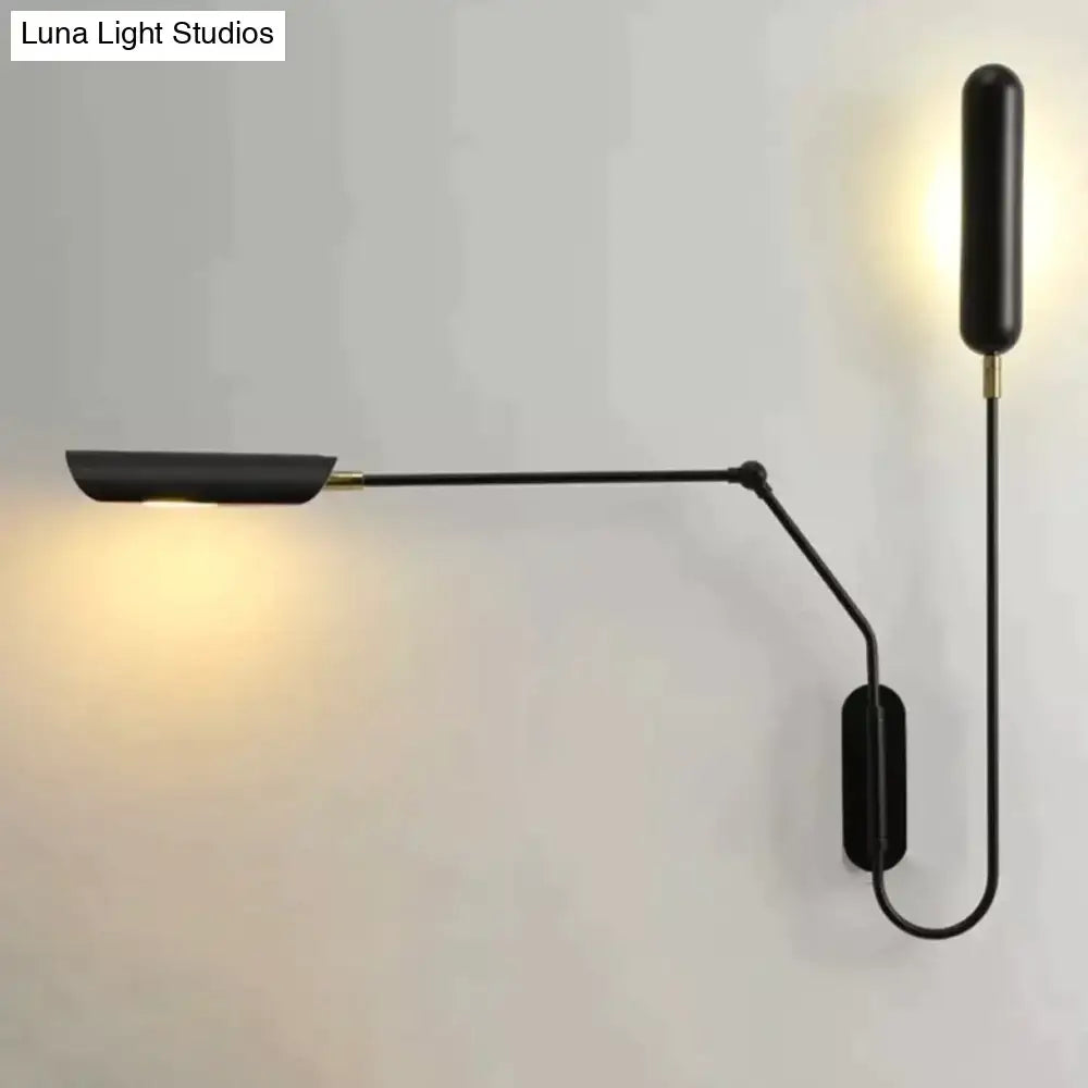 Black emma industrial wall lamp with a minimalist articulated arm and warm light ideal for bedroom reading