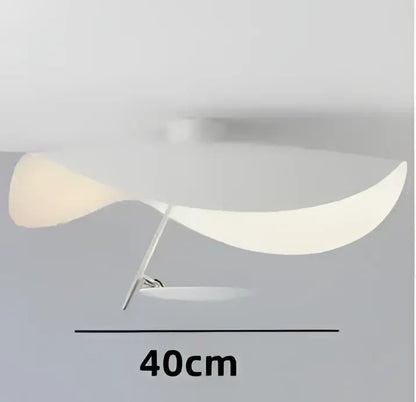 A decorbites lederam manta pendant light with a sleek white translucent shade and minimalist metallic base for dining room decor