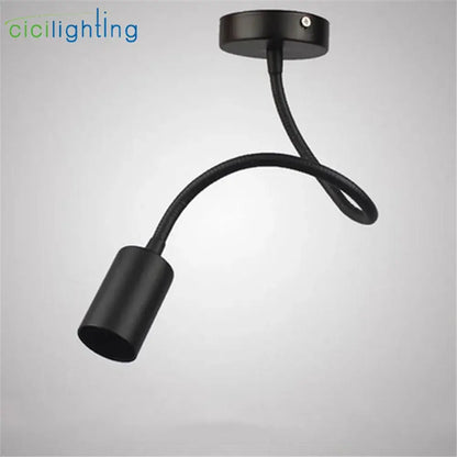 Black flexible industrial gooseneck track lighting with matte finish and cylindrical lamp head for clothing store decorbites industrial gooseneck