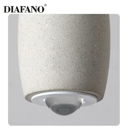 Diafano pendant light with speckled beige cement finish and metallic silver base ideal for industrial bedroom decorbites cement pendant