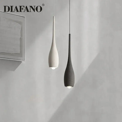 Two minimalist pendant lights by diafano with matte white and dark gray ceramic shades for decorbites cement pendant light