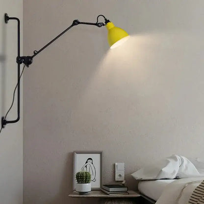Yellow industrial style wall lamp with black articulated arms adjustable for bedroom reading decorbites gras style