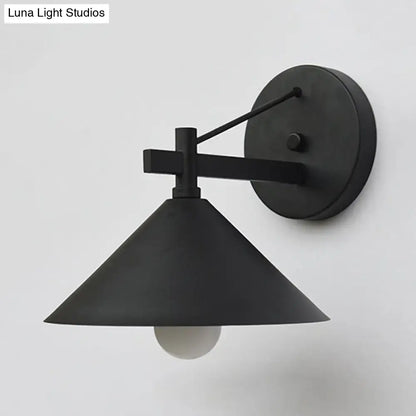 Black matte metal cone wall hanging light with a conical shade and minimalist geometric arm by DecorBites outdoor vintage sconce