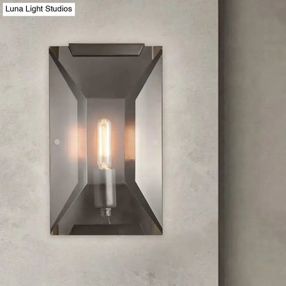 Modern industrial black metal wall mounted sconce light with sleek brushed metal frame and exposed filament bulb