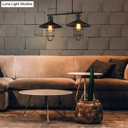 Decorbites™ nautical saucer island pendant lamp with black wire cage shade and exposed filament bulbs above sofa
