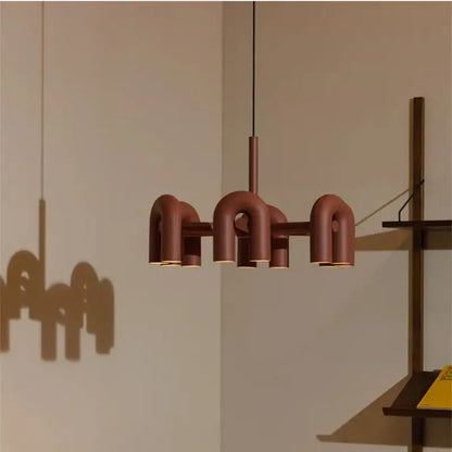 A rust-colored cirkus led metal pendant light with geometric u-shaped design for industrial kitchen decorbites cirkus lighting