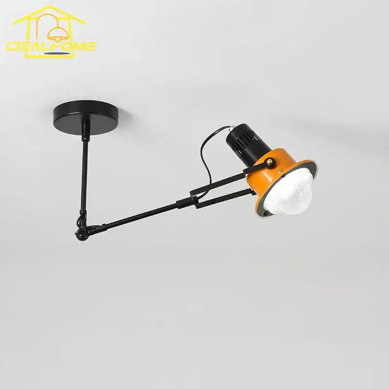 Adjustable industrial swing arm wall lamp with black metal arm and orange housing for bedroom decorbites industrial swing