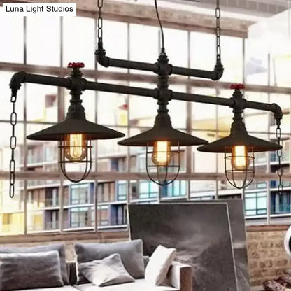 Industrial black pipe chandelier with red valve caps metal cage shades and three exposed filament bulbs for dining room use