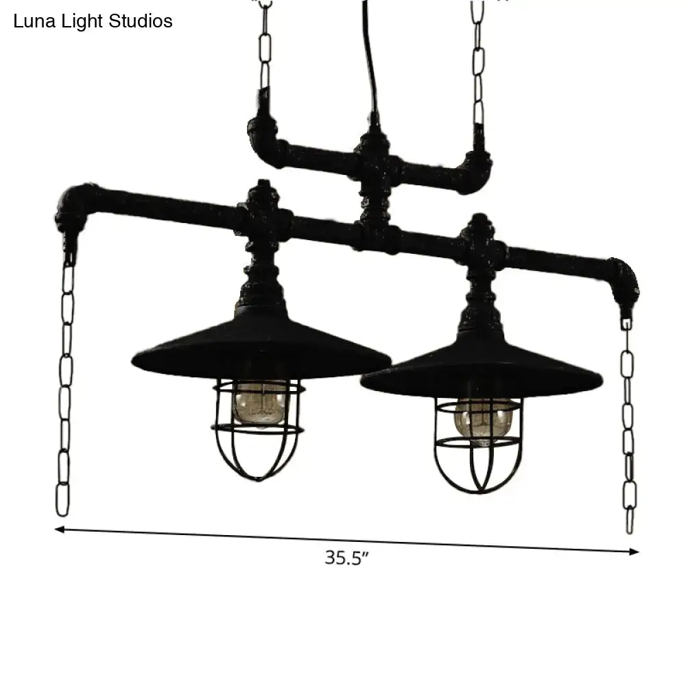 Industrial black pipe chandelier with two exposed bulbs and red valve caps suspended by chains for dining room lighting