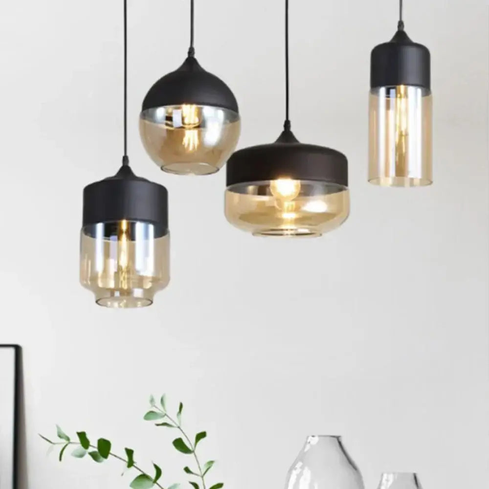 Modern industrial black and amber glass shade pendant light with sleek metal fixtures for kitchen decor