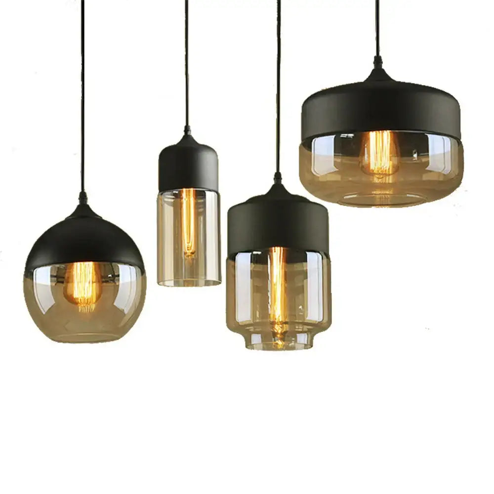 Set of three industrial black pendant lights with smoked glass shade pendant and visible Edison bulbs for kitchen decor