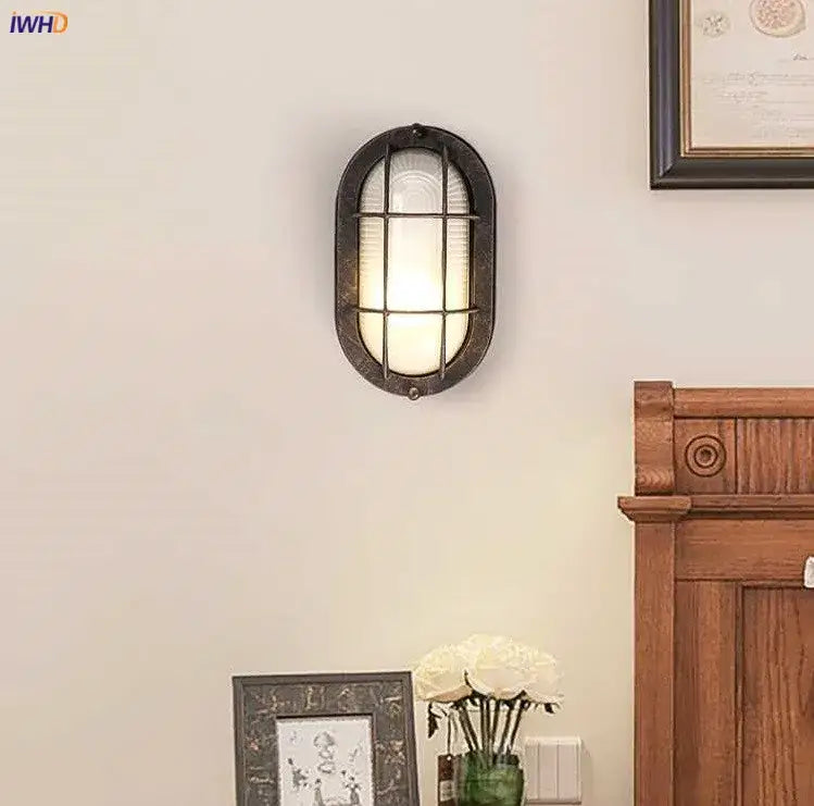Vintage-style oval wall lamp with dark bronze metal frame and frosted glass panels for decorbites industrial glass wall lighting