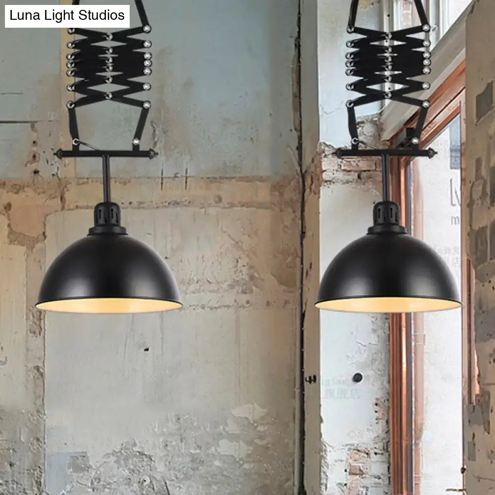 Black industrial-style pendant light with articulated arms and matte-finished dome shades in black white finish