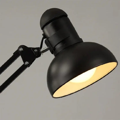 Black matte adjustable desk lamp with rounded dome shade paired with industrial black and white spider ceiling lamp