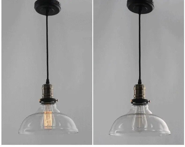 Clear glass pendant light with brass-finished socket and black cord ideal for industrial dining room lighting