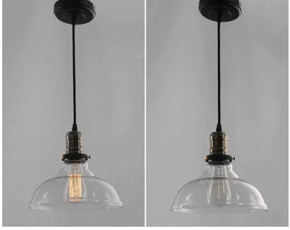Clear glass pendant light with brass-finished socket and black cord ideal for industrial dining room lighting