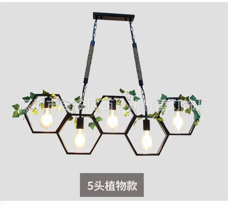 Black industrial style pendant light with brass hexagonal frame five exposed bulbs and green ivy decorbites industrial style