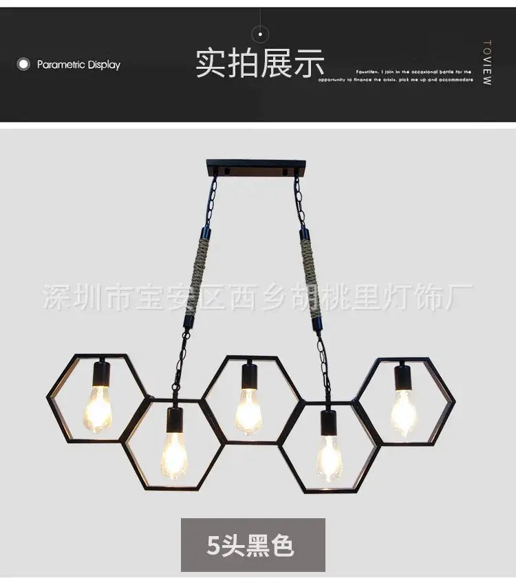 Black industrial style pendant light with five exposed bulbs and hexagonal brass frame for bar and restaurant decorbites decor