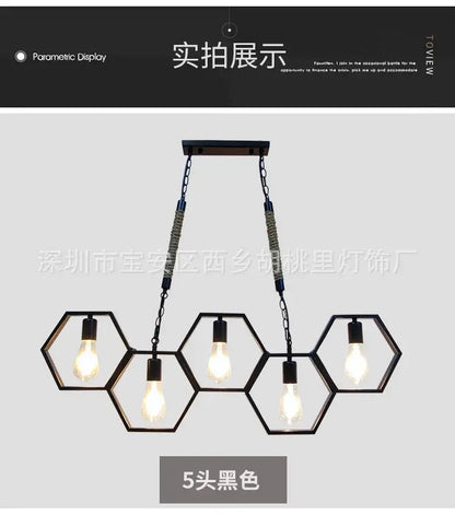 Black industrial style pendant light with five exposed bulbs and hexagonal brass frame for bar and restaurant decorbites decor