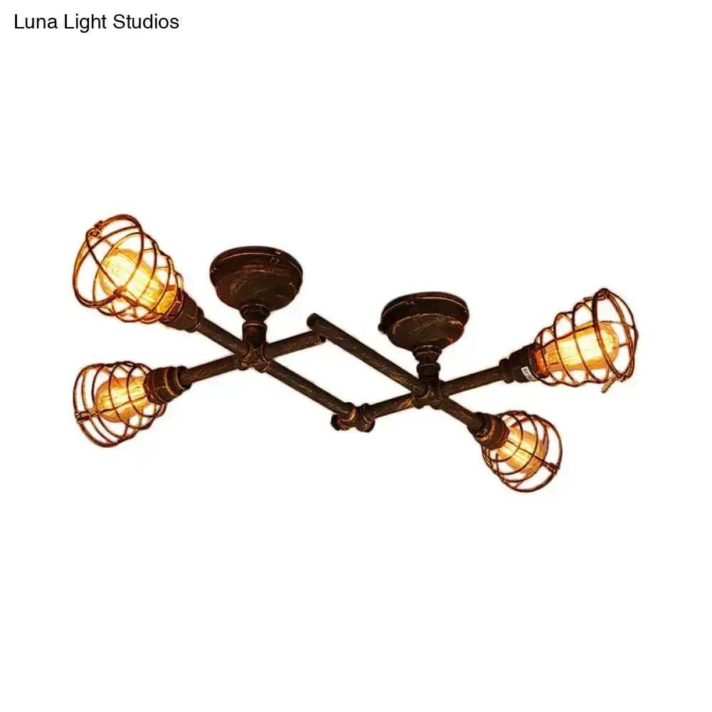Industrial brass intersecting piping ceiling light with four exposed Edison bulbs in dark bronze wrought iron cages