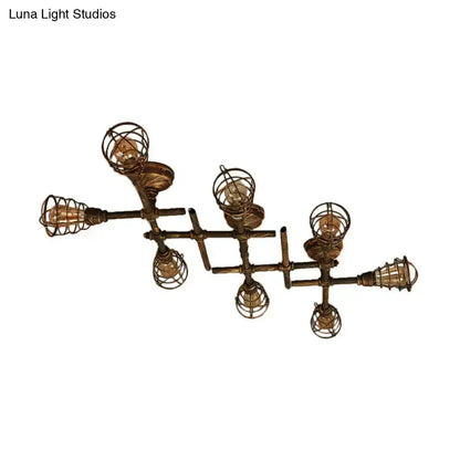 Industrial brass intersecting piping ceiling light with six exposed filament bulbs in wire cage for dining room