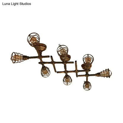 Industrial brass intersecting piping ceiling light with five filament bulbs encased in wire cages for dining room use