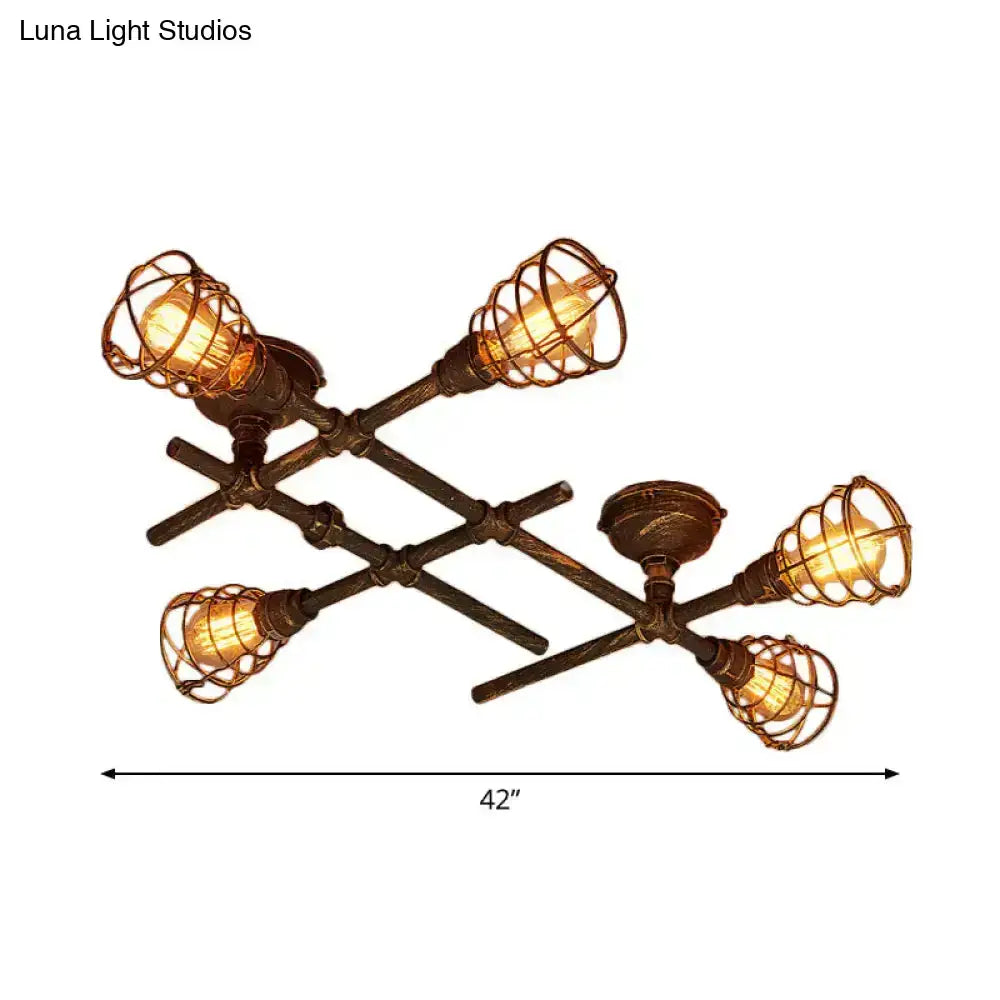 Industrial intersecting piping ceiling light with four exposed filament bulbs in dark bronze wire cage for dining room