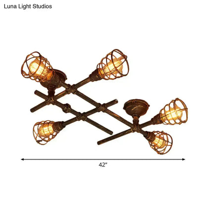 Industrial intersecting piping ceiling light with four exposed filament bulbs in dark bronze wire cage for dining room