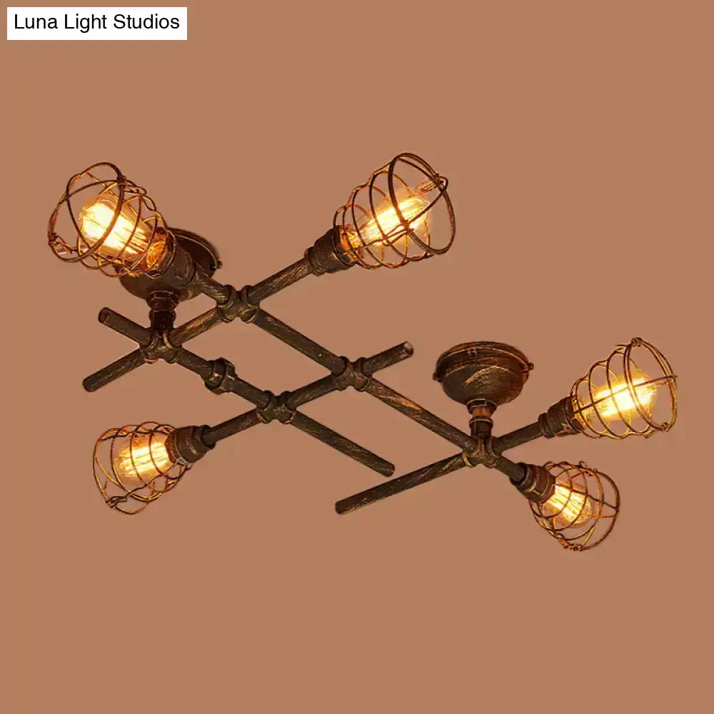 Industrial brass intersecting piping ceiling light with four exposed filament bulbs in dark bronze wire cages