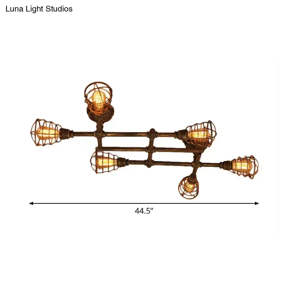Industrial brass intersecting piping ceiling light with five exposed filament bulbs in wire cages on dark bronze frame