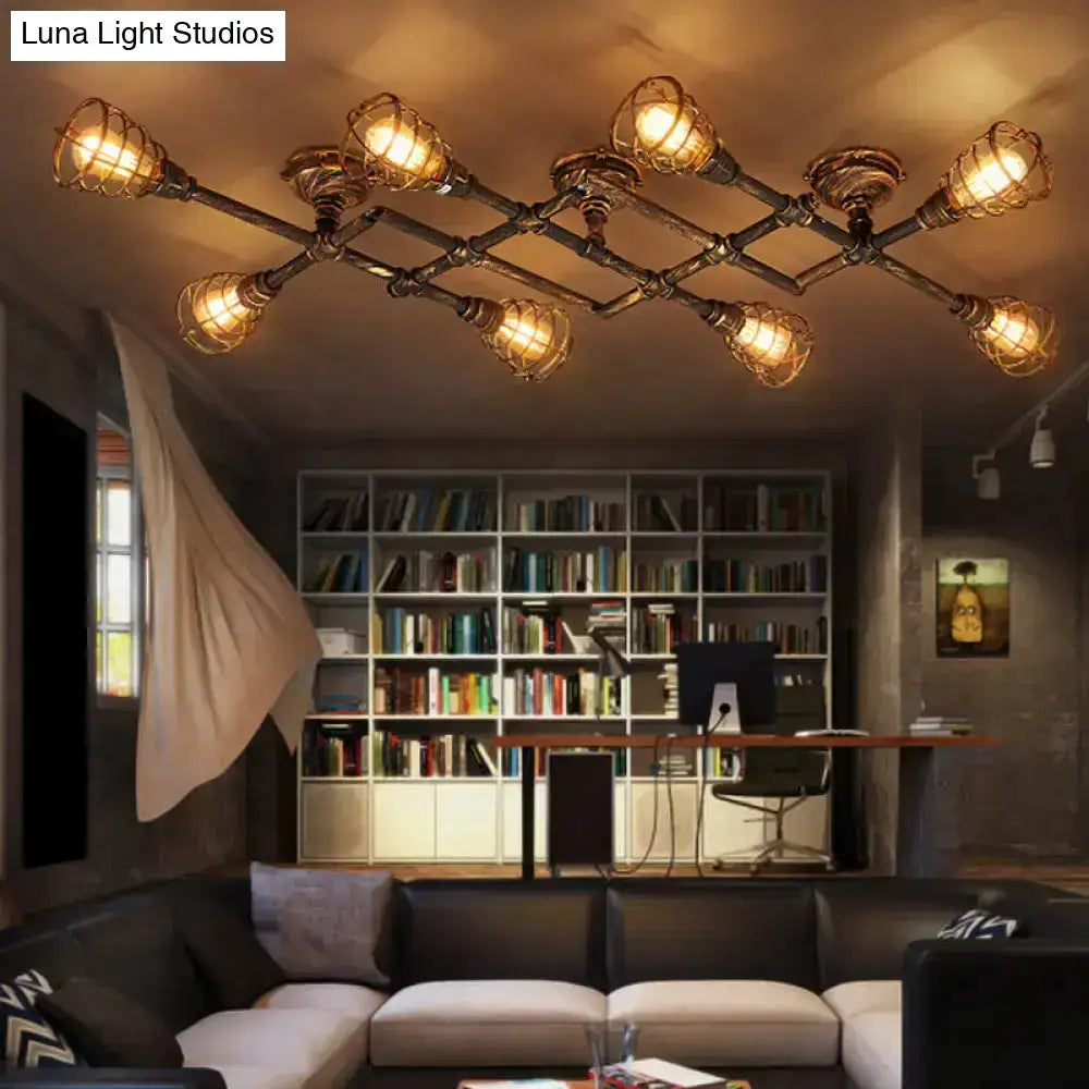 Industrial brass intersecting piping ceiling light with dark metallic frame and warm amber bulbs for dining rooms