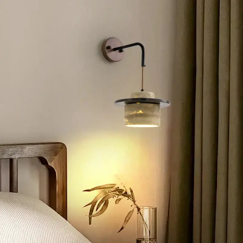 Industrial bronze and beige decorbites led wall light fixture with a curved black metal arm and textured glass shade