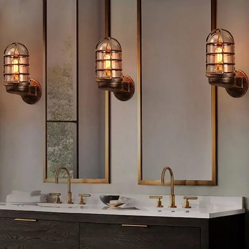 Three vintage-style industrial bronze iron cage guard wall sconces with glass enclosures and exposed filament bulbs for decorbites iron cage guard wall decor