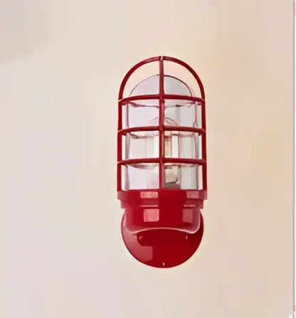 Red industrial-style iron cage guard wall sconce with bronze finish and clear glass panels for bedroom decorbites iron cage