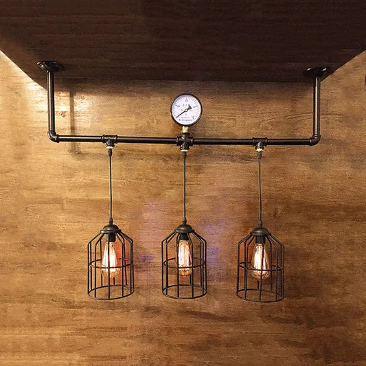 Decorbites™ bronze industrial linear hanging light with black pipe cage shades and a central pressure gauge for island lighting